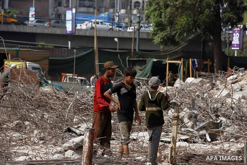 Egyptian laborers work during the demolition of the headquarters of the once-dominant party of ex-president Hosni Mubarak that was torched during the 2011 uprising that toppled him, on August 16, 2015 in the capital, Cai...