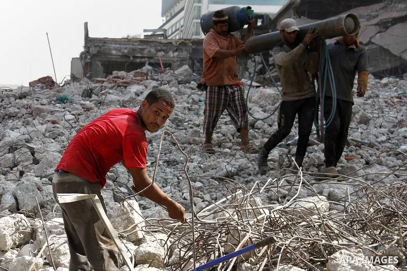 Egyptian laborers work during the demolition of the headquarters of the once-dominant party of ex-president Hosni Mubarak that was torched during the 2011 uprising that toppled him, on August 16, 2015 in the capital, Cai...