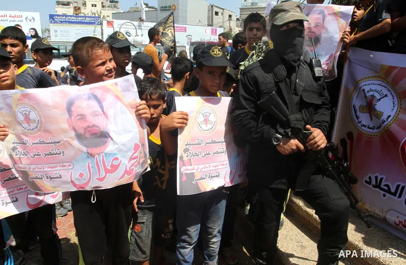 Palestinian children hold pictures of prisoner Mohammad Allan allegedly being held in an Israeli jail, during a march organized by the Islamic Jihad in Rafah in the southern Gaza Strip on August 16, 2015. Allan has been...