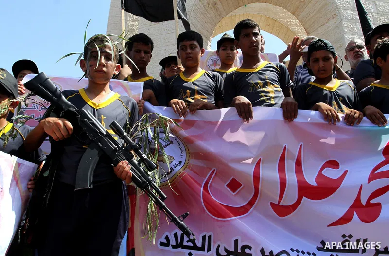 Palestinian children hold pictures of prisoner Mohammad Allan allegedly being held in an Israeli jail, during a march organized by the Islamic Jihad in Rafah in the southern Gaza Strip on August 16, 2015. Allan has been...