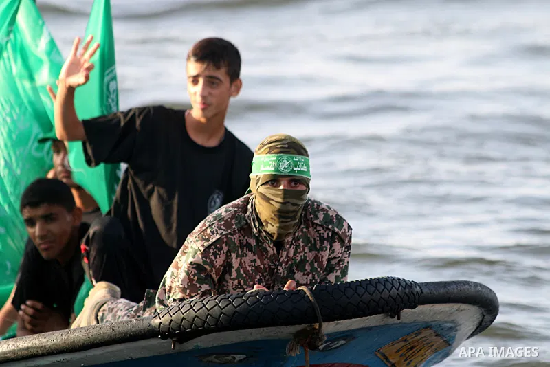 Palestinian youths participate in a military graduation ceremony of Ezzedine al-Qassam commandos, the armed wing of Hamas movement, in Gaza city on August 16, 2015. Some 200 youths participate in the training aimed to pr...
