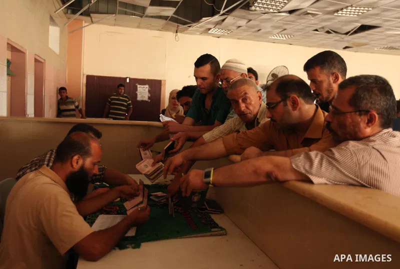 Palestinians present their documents as they ask for travel permits to cross into Egypt, at the Rafah border crossing between Egypt and the southern Gaza Strip August 17, 2015. Egypt opened the Rafah border crossing on M...