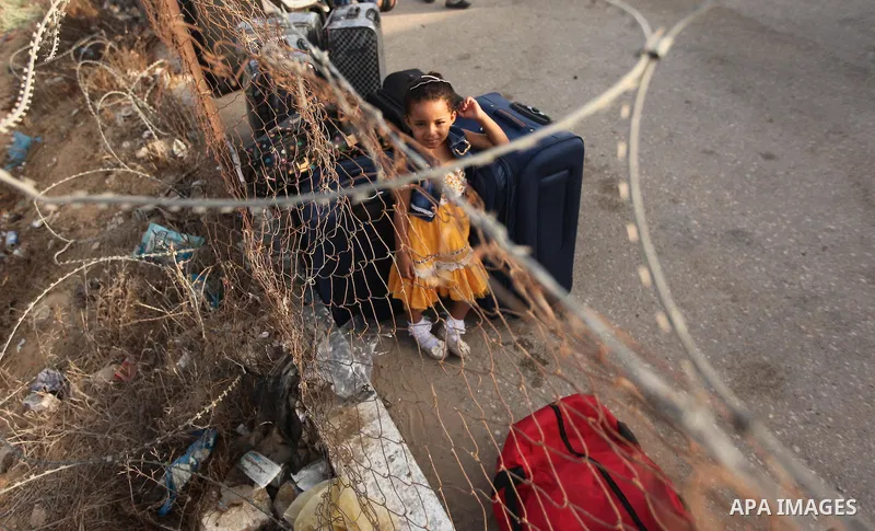 Palestinian gather at the Rafah border crossing in the southern Gaza Strip as they wait for permission to enter Egypt on August 17, 2015. Egypt opened the Rafah border crossing on Monday for four days to allow Palestinia...