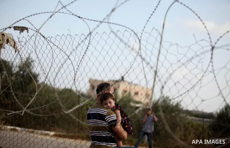 Palestinian gather at the Rafah border crossing in the southern Gaza Strip as they wait for permission to enter Egypt on August 17, 2015. Egypt opened the Rafah border crossing on Monday for four days to allow Palestinia...