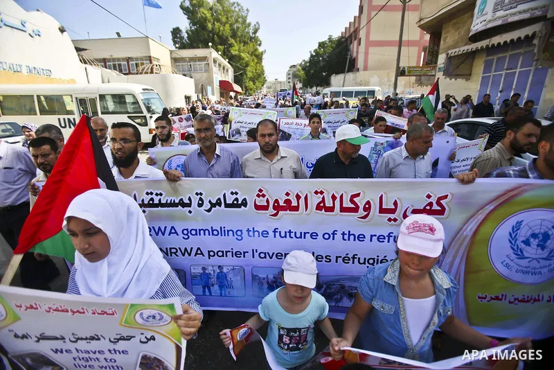Palestinian children and teachers hold placards during a protest against the reduction of educational programs given by the United Nations Relief and Works Agency (UNRWA), in Gaza City August 17, 2015. Photo by Mohammed...