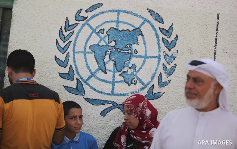Palestinian children and teachers hold placards during a protest against the reduction of educational programs given by the United Nations Relief and Works Agency (UNRWA), in Gaza City August 17, 2015. Photo by Ashraf Am...
