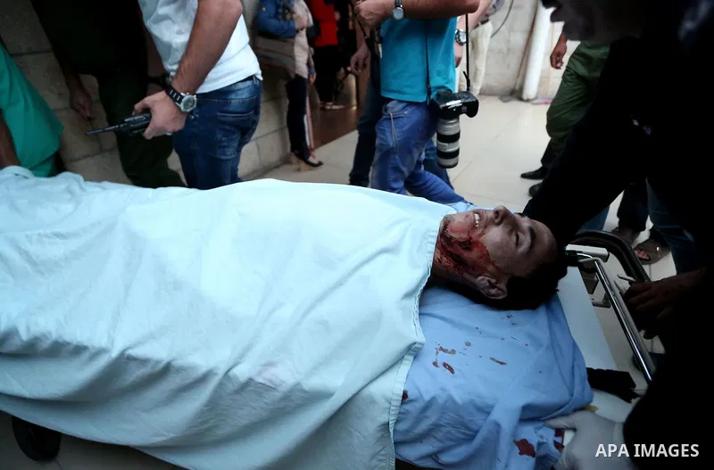 The body of a Palestinian is rushed to Rafidya Hospital in the West Bank city of Nablus on August 17, 2015. Israeli troops shot dead a young Palestinian man at Tappuah junction, known to Palestinians as Zaatara military...