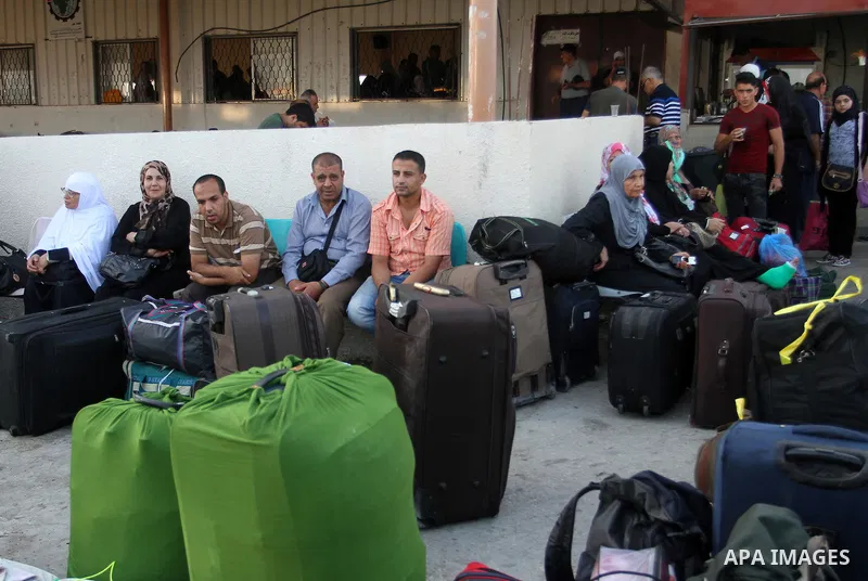 Palestinians wait for travel permits to cross into Egypt at the Rafah border crossing between Egypt and the southern Gaza Strip August 18, 2015. Egypt opened the Rafah border crossing on Monday for four days to allow Pal...