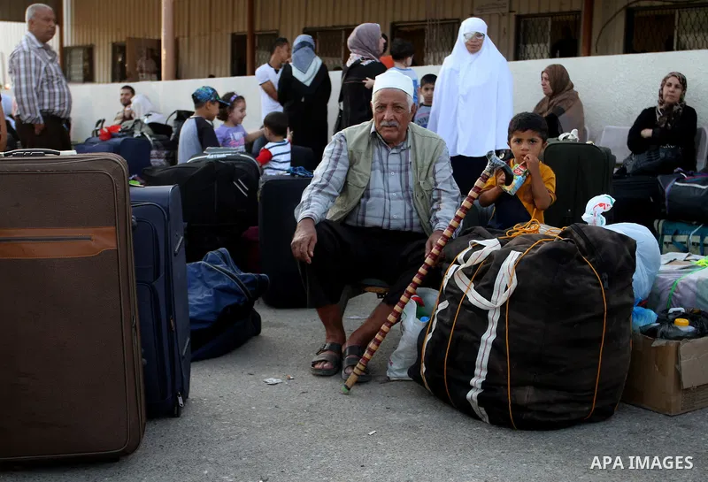 Palestinians wait for travel permits to cross into Egypt at the Rafah border crossing between Egypt and the southern Gaza Strip August 18, 2015. Egypt opened the Rafah border crossing on Monday for four days to allow Pal...