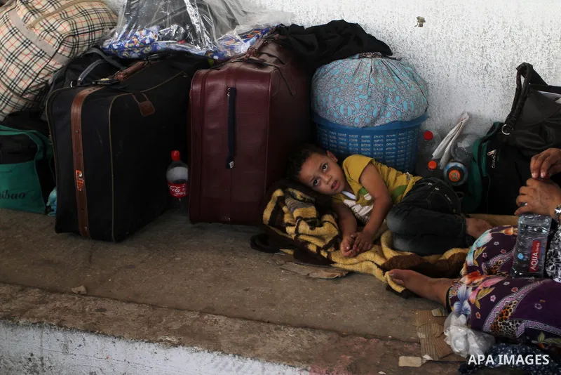 Palestinians wait for travel permits to cross into Egypt at the Rafah border crossing between Egypt and the southern Gaza Strip August 18, 2015. Egypt opened the Rafah border crossing on Monday for four days to allow Pal...