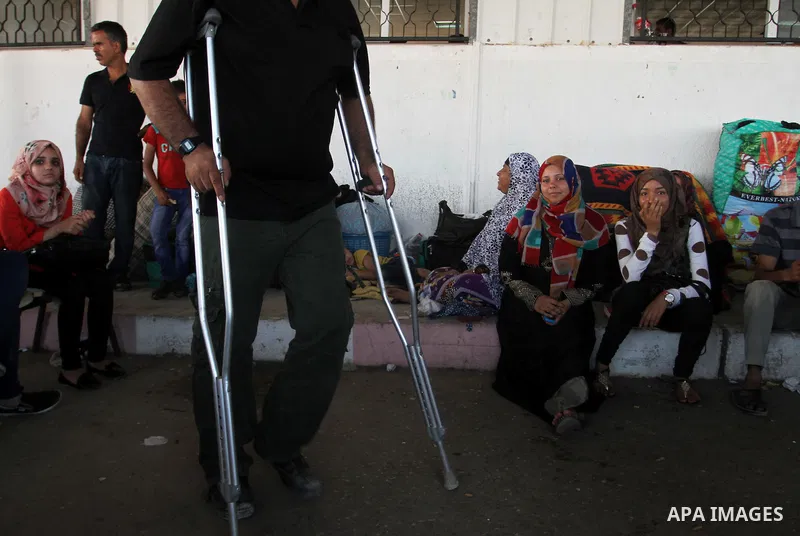Palestinians wait for travel permits to cross into Egypt at the Rafah border crossing between Egypt and the southern Gaza Strip August 18, 2015. Egypt opened the Rafah border crossing on Monday for four days to allow Pal...