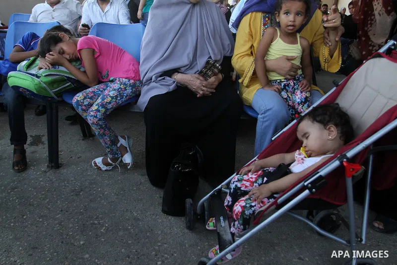 Palestinians wait for travel permits to cross into Egypt at the Rafah border crossing between Egypt and the southern Gaza Strip August 18, 2015. Egypt opened the Rafah border crossing on Monday for four days to allow Pal...