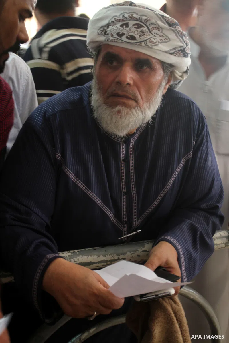 Palestinians wait for travel permits to cross into Egypt at the Rafah border crossing between Egypt and the southern Gaza Strip August 18, 2015. Egypt opened the Rafah border crossing on Monday for four days to allow Pal...