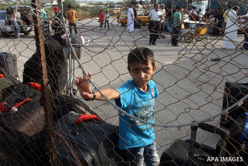 Palestinians wait for travel permits to cross into Egypt at the Rafah border crossing between Egypt and the southern Gaza Strip August 18, 2015. Egypt opened the Rafah border crossing on Monday for four days to allow Pal...