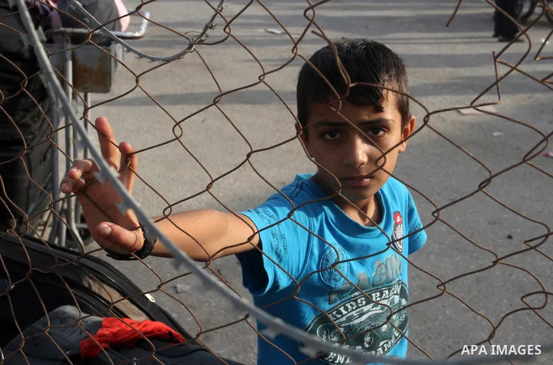 Palestinians wait for travel permits to cross into Egypt at the Rafah border crossing between Egypt and the southern Gaza Strip August 18, 2015. Egypt opened the Rafah border crossing on Monday for four days to allow Pal...