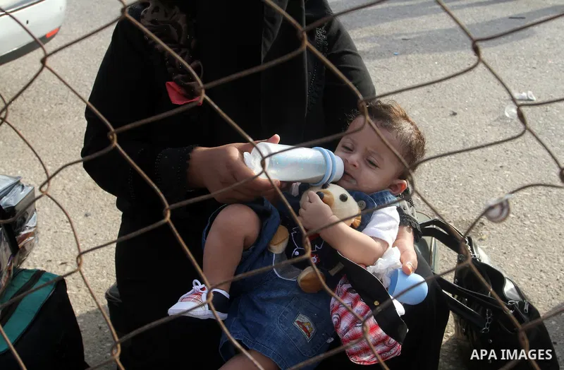 Palestinians wait for travel permits to cross into Egypt at the Rafah border crossing between Egypt and the southern Gaza Strip August 18, 2015. Egypt opened the Rafah border crossing on Monday for four days to allow Pal...