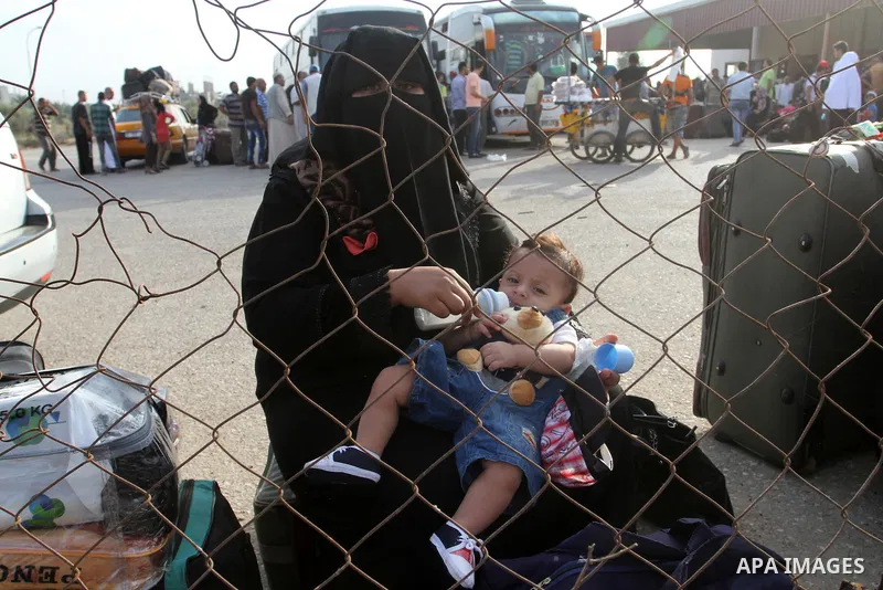 Palestinians wait for travel permits to cross into Egypt at the Rafah border crossing between Egypt and the southern Gaza Strip August 18, 2015. Egypt opened the Rafah border crossing on Monday for four days to allow Pal...