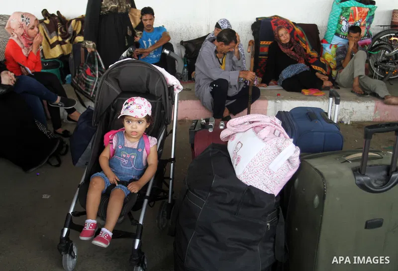 Palestinians wait for travel permits to cross into Egypt at the Rafah border crossing between Egypt and the southern Gaza Strip August 18, 2015. Egypt opened the Rafah border crossing on Monday for four days to allow Pal...