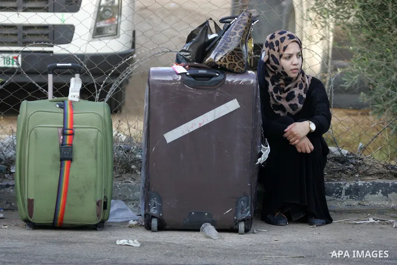 Palestinians wait for travel permits to cross into Egypt at the Rafah border crossing between Egypt and the southern Gaza Strip August 18, 2015. Egypt opened the Rafah border crossing on Monday for four days to allow Pal...