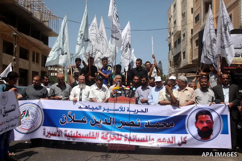 Palestinians hold placards during a protest to show solidarity with prisoner Mohammad Allan allegedly being held in an Israeli jail, in Gaza city on August 19, 2015. The Israeli military prosecutor intends to request cou...