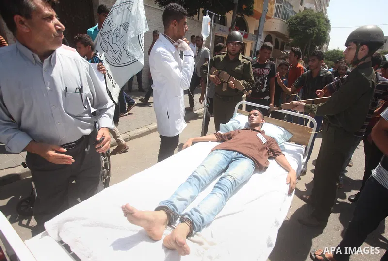 Palestinian youths take part in a theatrical presentation during a protest to show solidarity with prisoner Mohammad Allan allegedly being held in an Israeli jail, in Gaza city on August 19, 2015. The Israeli military pr...
