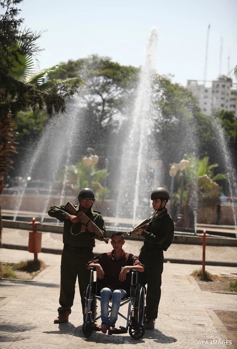 Palestinian youths take part in a theatrical presentation during a protest to show solidarity with prisoner Mohammad Allan allegedly being held in an Israeli jail, in Gaza city on August 19, 2015. The Israeli military pr...
