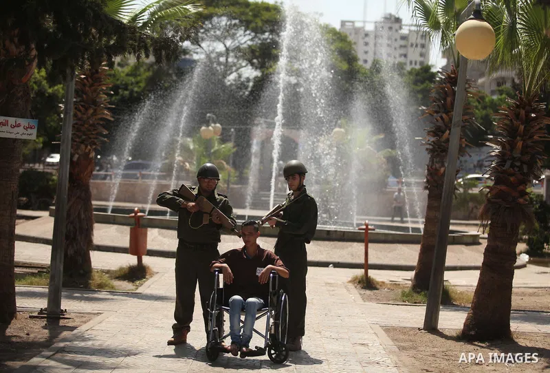 Palestinian youths take part in a theatrical presentation during a protest to show solidarity with prisoner Mohammad Allan allegedly being held in an Israeli jail, in Gaza city on August 19, 2015. The Israeli military pr...