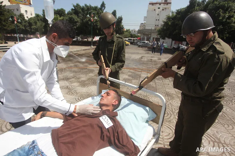 Palestinian youths take part in a theatrical presentation during a protest to show solidarity with prisoner Mohammad Allan allegedly being held in an Israeli jail, in Gaza city on August 19, 2015. The Israeli military pr...
