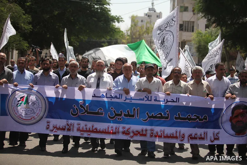 Palestinians hold placards during a protest to show solidarity with prisoner Mohammad Allan allegedly being held in an Israeli jail, in Gaza city on August 19, 2015. The Israeli military prosecutor intends to request cou...