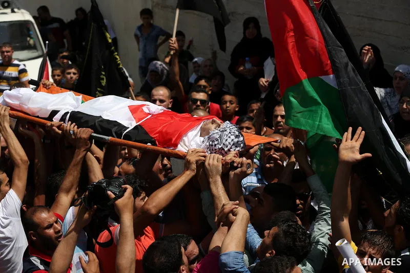 Mourners carry the body of Palestinian man Mohammad El-Atrash during his funeral in the West Bank village of Kofr Raee near Jenin August 18, 2015. El-Atrash was shot dead on Monday by Israeli police troopers after he sta...