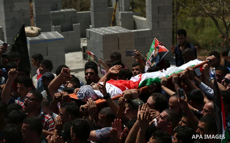Mourners carry the body of Palestinian man Mohammad El-Atrash during his funeral in the West Bank village of Kofr Raee near Jenin August 18, 2015. El-Atrash was shot dead on Monday by Israeli police troopers after he sta...