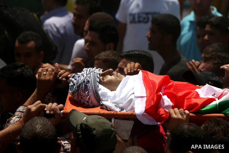 Mourners carry the body of Palestinian man Mohammad El-Atrash during his funeral in the West Bank village of Kofr Raee near Jenin August 18, 2015. El-Atrash was shot dead on Monday by Israeli police troopers after he sta...