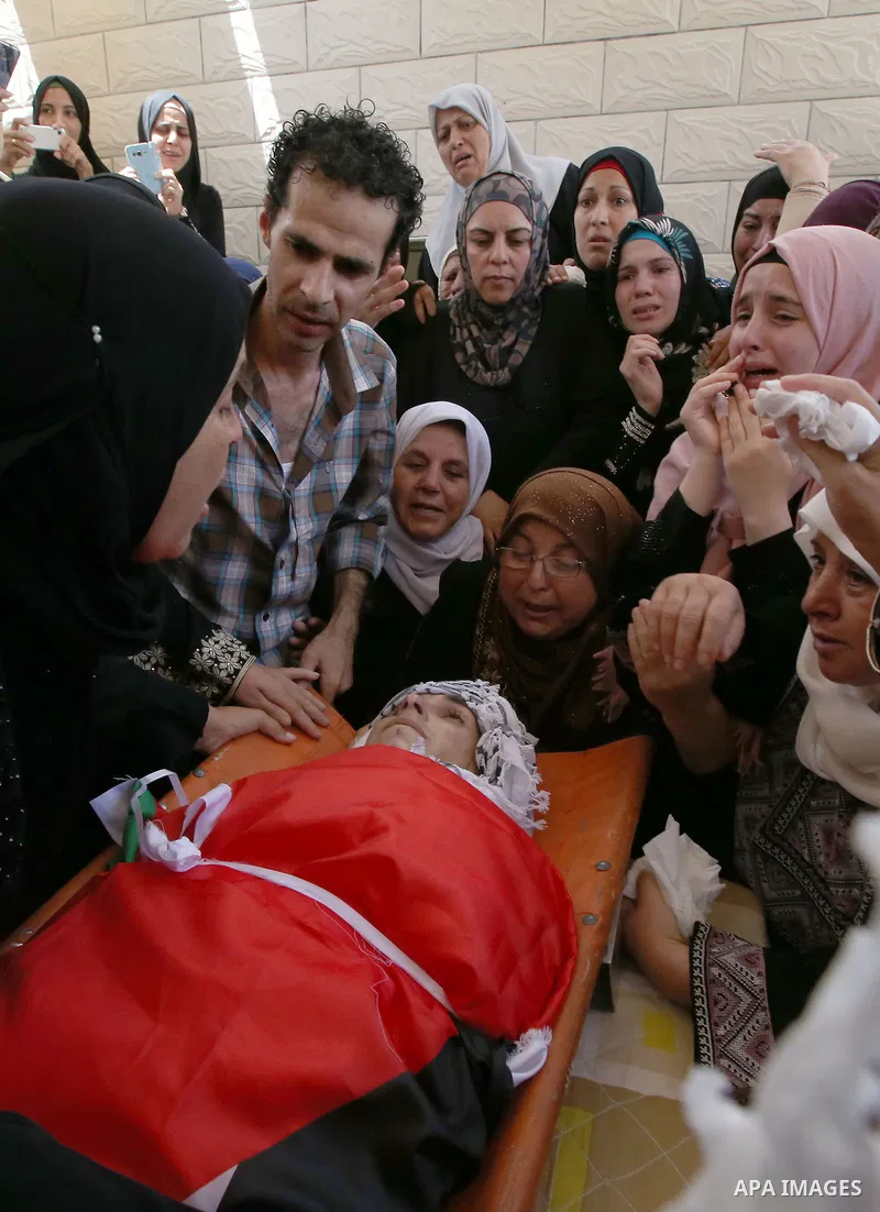 Relatives of Palestinian man Mohammad El-Atrash mourn during his funeral in the West Bank village of Kofr Raee near Jenin August 18, 2015. Amshah was shot dead on Monday by Israeli police troopers after he stabbed and li...