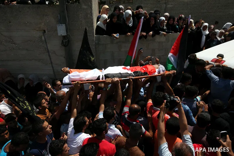 Mourners carry the body of Palestinian man Mohammad El-Atrash during his funeral in the West Bank village of Kofr Raee near Jenin August 18, 2015. El-Atrash was shot dead on Monday by Israeli police troopers after he sta...