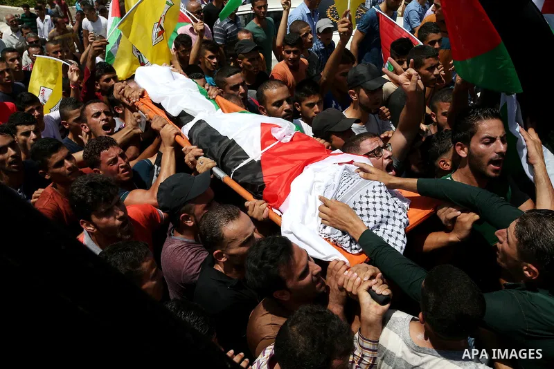 Mourners carry the body of Palestinian man Mohammad El-Atrash during his funeral in the West Bank village of Kofr Raee near Jenin August 18, 2015. El-Atrash was shot dead on Monday by Israeli police troopers after he sta...