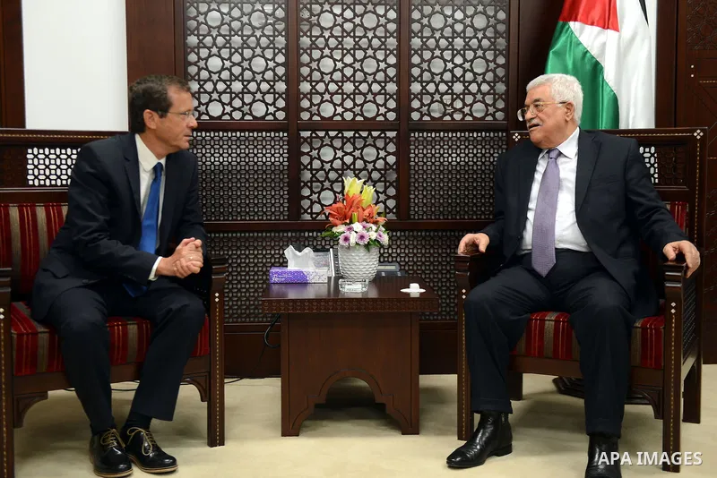 Palestinian President Mahmoud Abbas meets with Isaac Herzog, leader of the Israeli Labour Party, at Abbas's headquarter in the West Bank city of Ramallah August 18, 2015. Photo by Thaer Ganaim