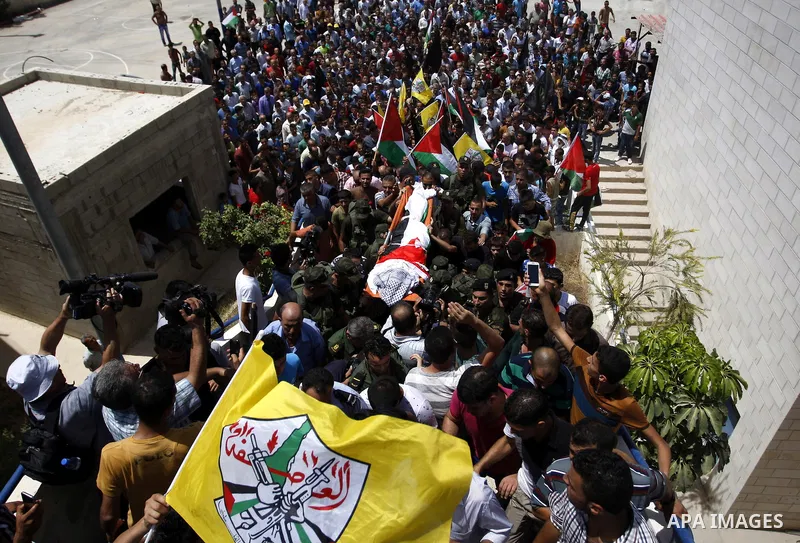 Mourners carry the body of Palestinian man Mohammad El-Atrash during his funeral in the West Bank village of Kofr Raee near Jenin August 18, 2015. El-Atrash was shot dead on Monday by Israeli police troopers after he sta...