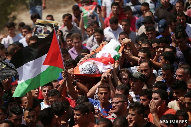 Mourners carry the body of Palestinian man Mohammad El-Atrash during his funeral in the West Bank village of Kofr Raee near Jenin August 18, 2015. El-Atrash was shot dead on Monday by Israeli police troopers after he sta...