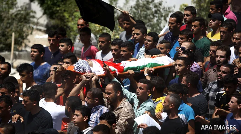 Mourners carry the body of Palestinian man Mohammad El-Atrash during his funeral in the West Bank village of Kofr Raee near Jenin August 18, 2015. El-Atrash was shot dead on Monday by Israeli police troopers after he sta...