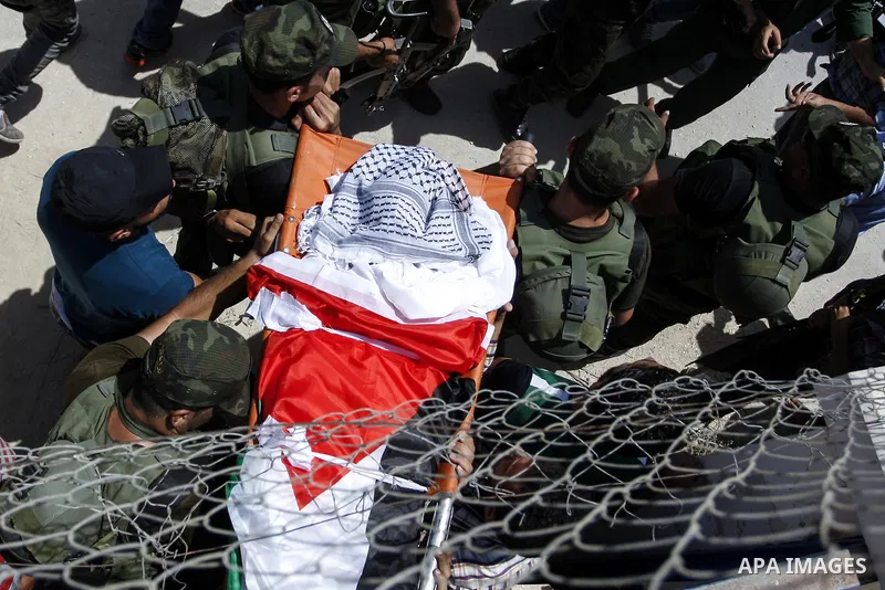 Mourners carry the body of Palestinian man Mohammad El-Atrash during his funeral in the West Bank village of Kofr Raee near Jenin August 18, 2015. El-Atrash was shot dead on Monday by Israeli police troopers after he sta...