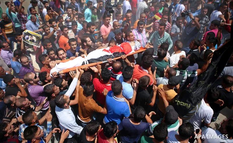 Mourners carry the body of Palestinian man Mohammad El-Atrash during his funeral in the West Bank village of Kofr Raee near Jenin August 18, 2015. El-Atrash was shot dead on Monday by Israeli police troopers after he sta...