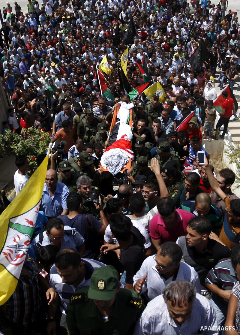 Mourners carry the body of Palestinian man Mohammad El-Atrash during his funeral in the West Bank village of Kofr Raee near Jenin August 18, 2015. El-Atrash was shot dead on Monday by Israeli police troopers after he sta...
