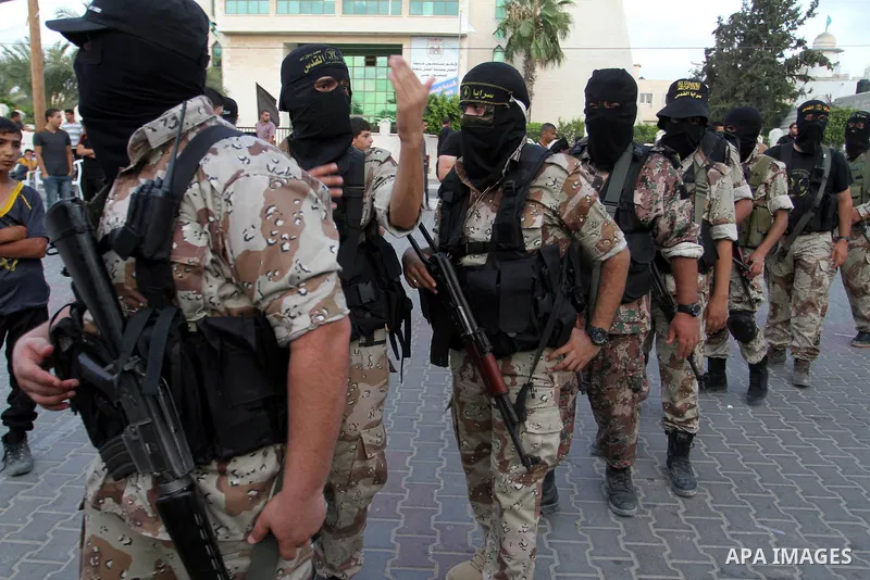 Militants of Al-Quds brigades, the armed wing of Islamic Jihad movement, take part in a graduation ceremony of a military-style camp organized by their movement Khan Younis in the southern Gaza Strip, on August 18, 2015....