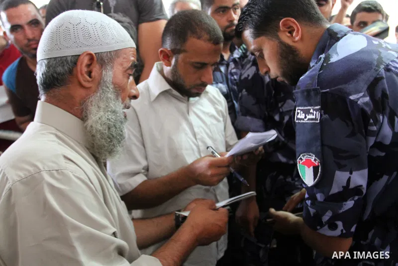 Palestinians wait for travel permits to cross into Egypt at the Rafah border crossing between Egypt and the southern Gaza Strip August 19, 2015. Egypt opened the Rafah border crossing on Monday for four days to allow Pal...