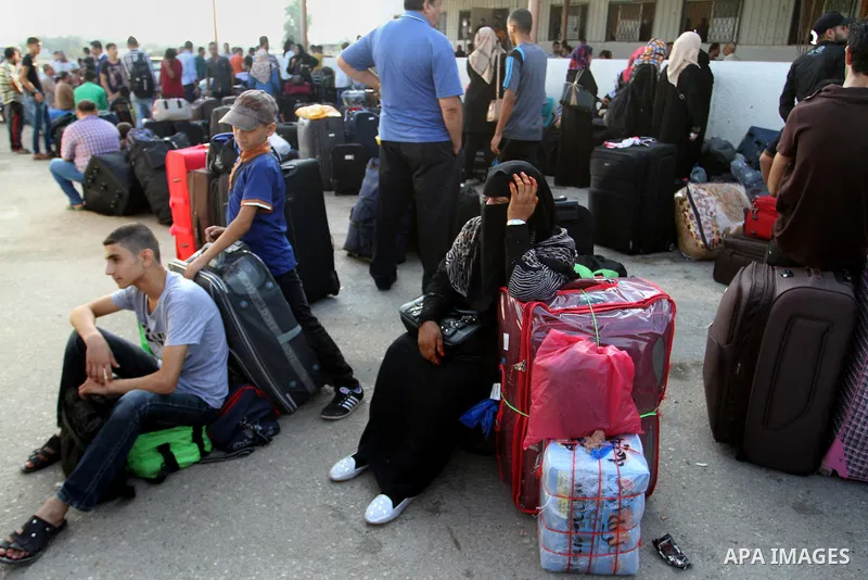 Palestinians wait for travel permits to cross into Egypt at the Rafah border crossing between Egypt and the southern Gaza Strip August 19, 2015. Egypt opened the Rafah border crossing on Monday for four days to allow Pal...