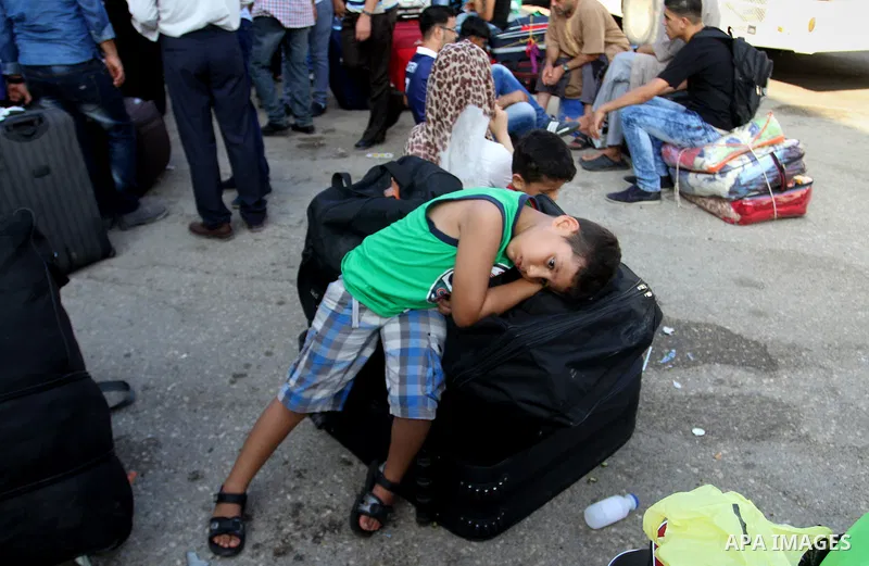 Palestinians wait for travel permits to cross into Egypt at the Rafah border crossing between Egypt and the southern Gaza Strip August 19, 2015. Egypt opened the Rafah border crossing on Monday for four days to allow Pal...