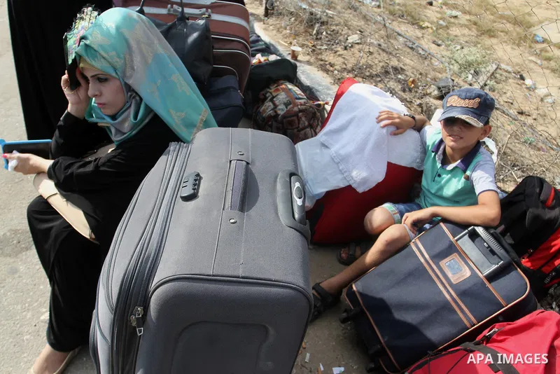 Palestinians wait for travel permits to cross into Egypt at the Rafah border crossing between Egypt and the southern Gaza Strip August 19, 2015. Egypt opened the Rafah border crossing on Monday for four days to allow Pal...
