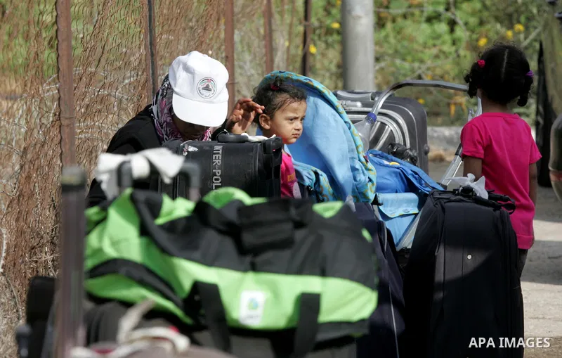 Palestinians wait for travel permits to cross into Egypt at the Rafah border crossing between Egypt and the southern Gaza Strip August 19, 2015. Egypt opened the Rafah border crossing on Monday for four days to allow Pal...