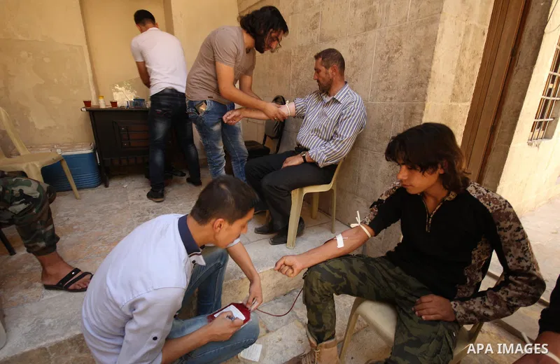 Syrians donate blood at Blood department in the old city of Aleppo, on August 19, 2015. A report from the Syrian Observatory for Human Rights (SOHR) claims that over 1,000 children have been killed in airstrikes during t...