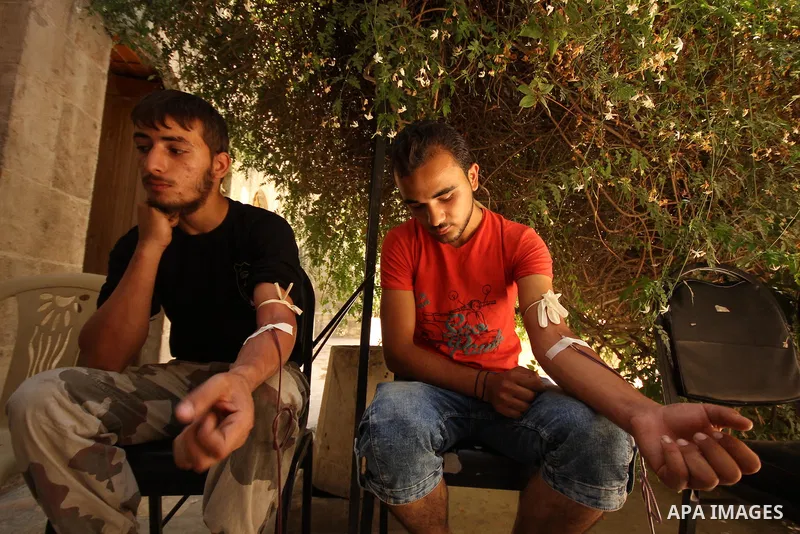 Syrians donate blood at Blood department in the old city of Aleppo, on August 19, 2015. A report from the Syrian Observatory for Human Rights (SOHR) claims that over 1,000 children have been killed in airstrikes during t...